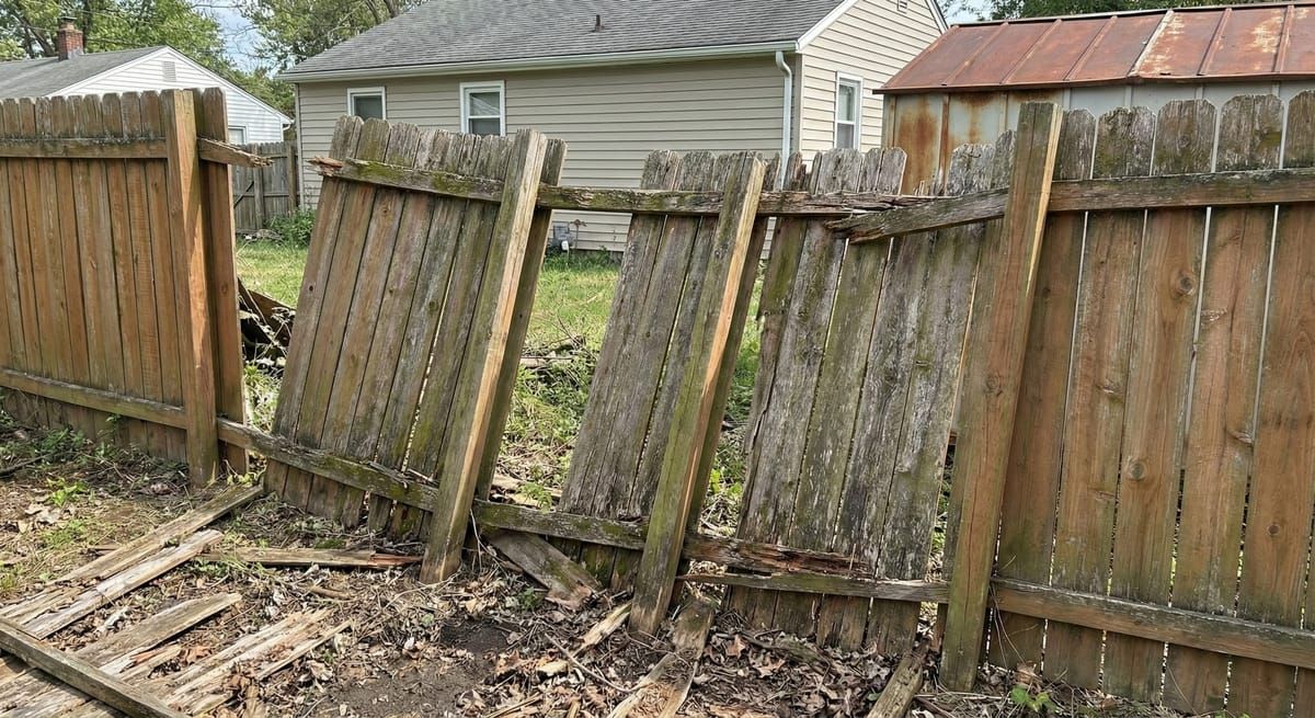Damaged fence before professional repair